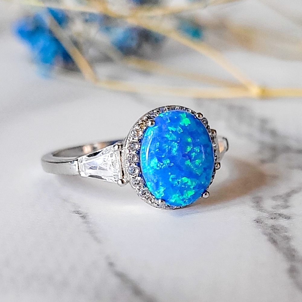 925 Sterling Silver Oval Blue Fire Opal Halo Ring with Baguette and CZ Accents